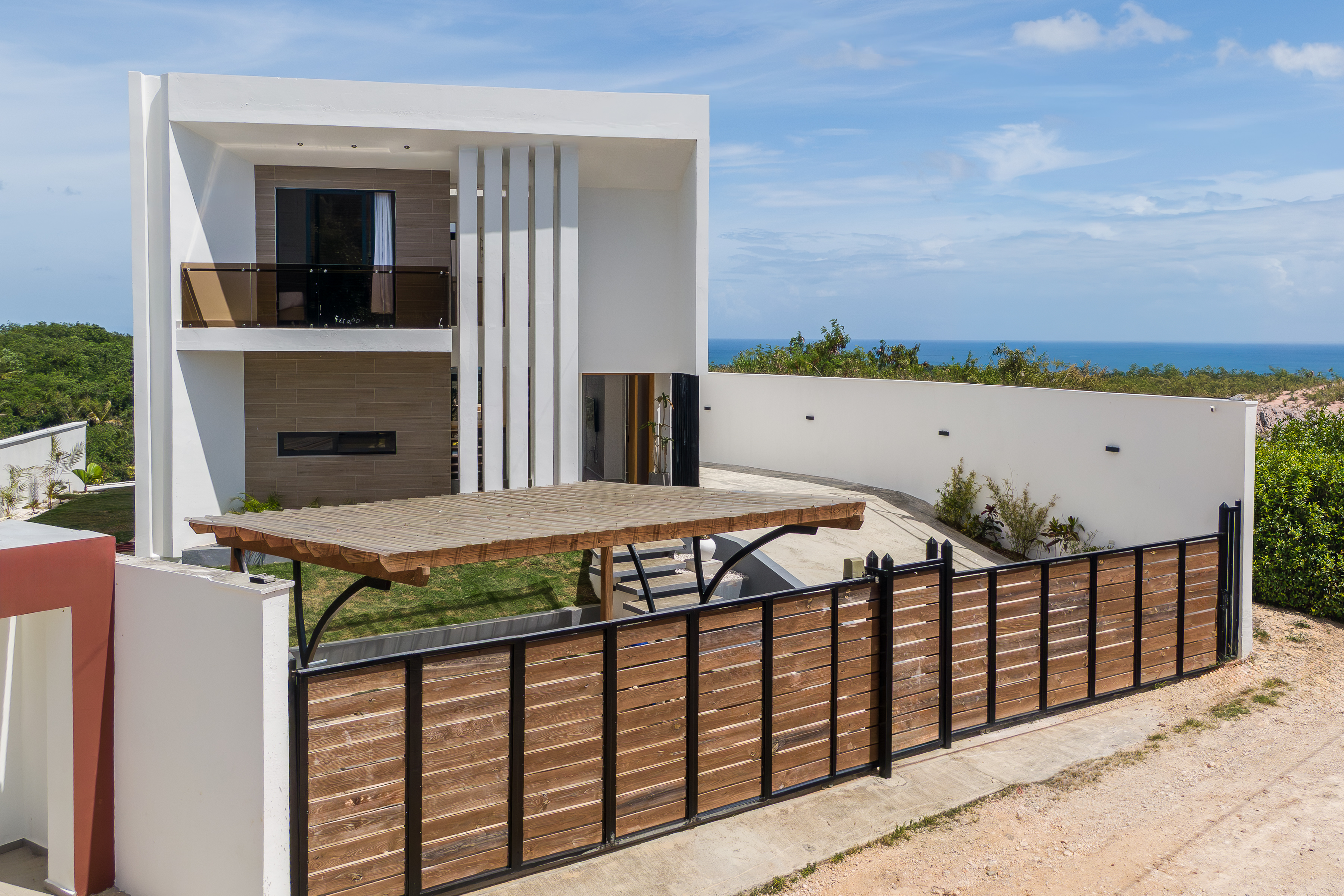 Villa facade with Caribbean sea visible in the background